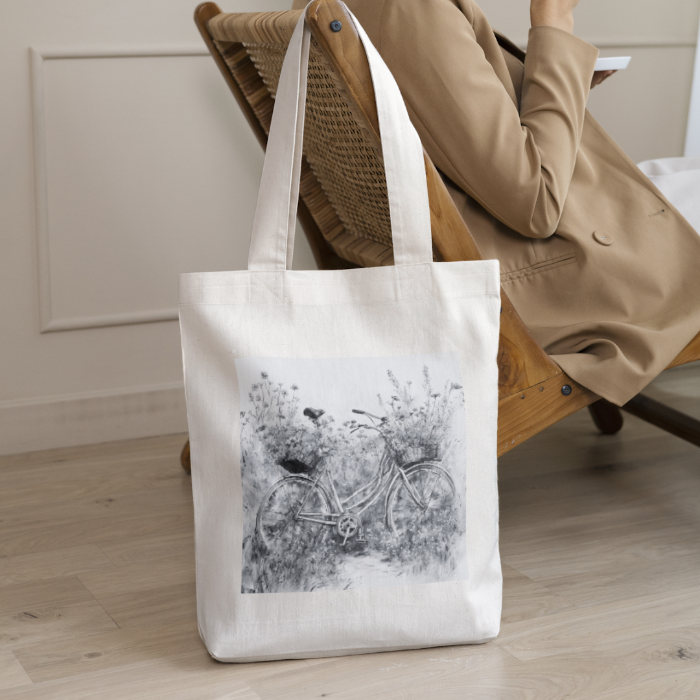 Woman sitting on a chair in livingroom with wildflower totebag