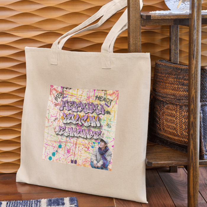 Woman holding natural canvas totebag with grafitti style Hey mama lyrics J-hope of BTS