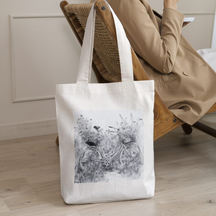 Woman sitting on a chair in livingroom with wildflower totebag 