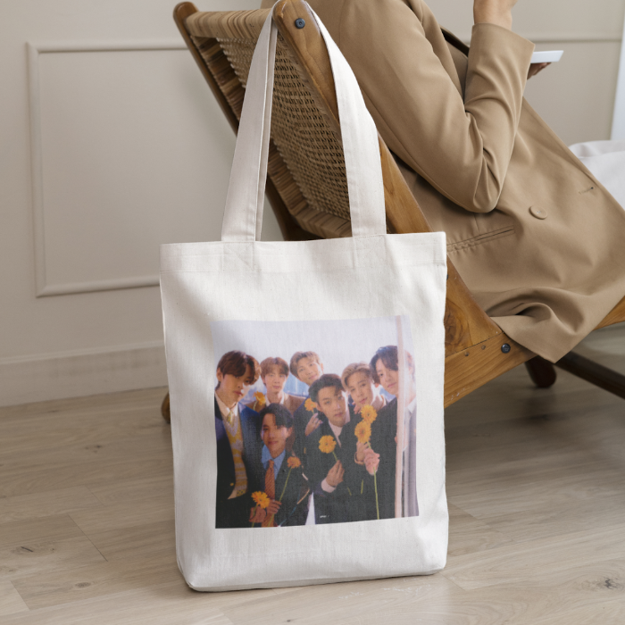 Woman sitting on chair with totebag bts flowers