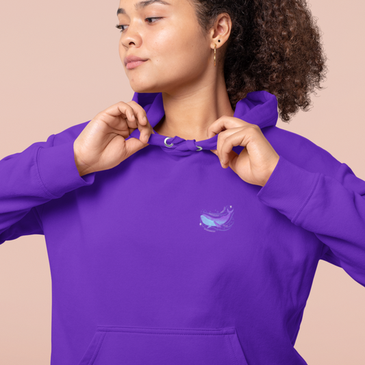 BTS hoodie in purple featuring a Whalien 52-inspired whale design, modeled by a smiling woman