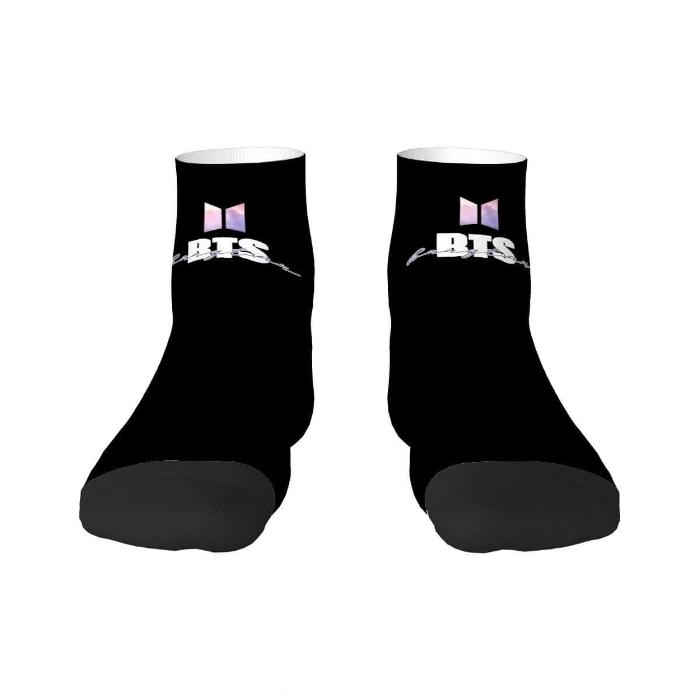 Black BTS tube socks with subtle logo, perfect for fans. Made with 95% polyester, 5% spandex. Ideal for everyday wear and gifting.