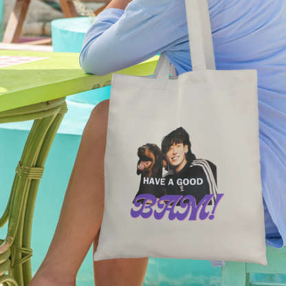 Woman-sitting-on-chair-next-to-table-with-canvas-totebag-JK-BAM