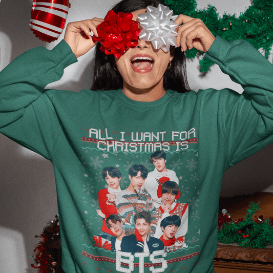 Person wearing BTS Christmas sweater with festive bows over eyes, showcasing a group photo of BTS and holiday cheer design.