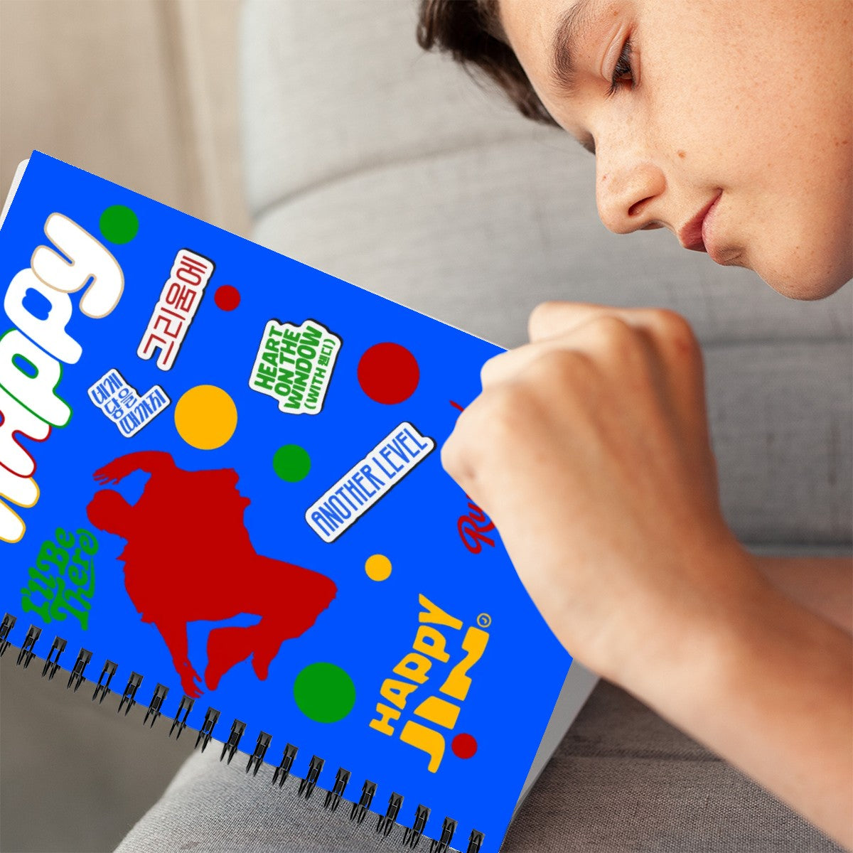 Young boy holding Happy Jin notebook