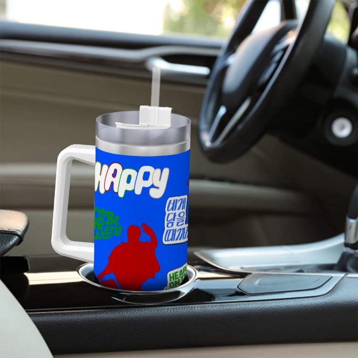 Travel mug with Jin's Happy album inspired design in a car