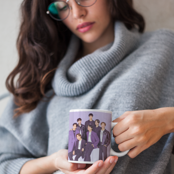 woman holding a mug with BTS loading 2025 design, anticipating for their return after enlistment