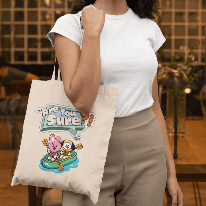 woman holding natural beige totebag with chimmy cooky are you sure design inspired by travel docu AYS!