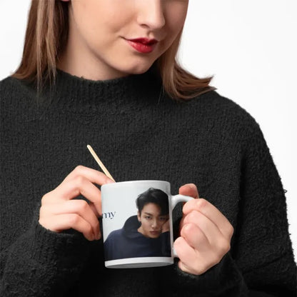 Woman with black wool sweater holding a jungkook euphoria mug