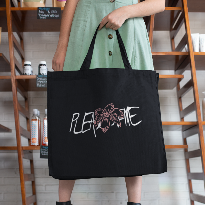 woman at a grocery store holding a totebag with JK tigerlily design