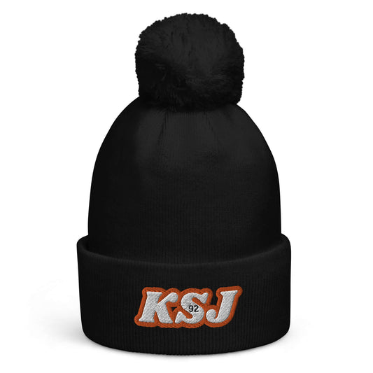 Jin's Warm and Bright Pom Pom Beanie with KSJ embroidery in black, made from soft-touch acrylic to keep you cozy and stylish.