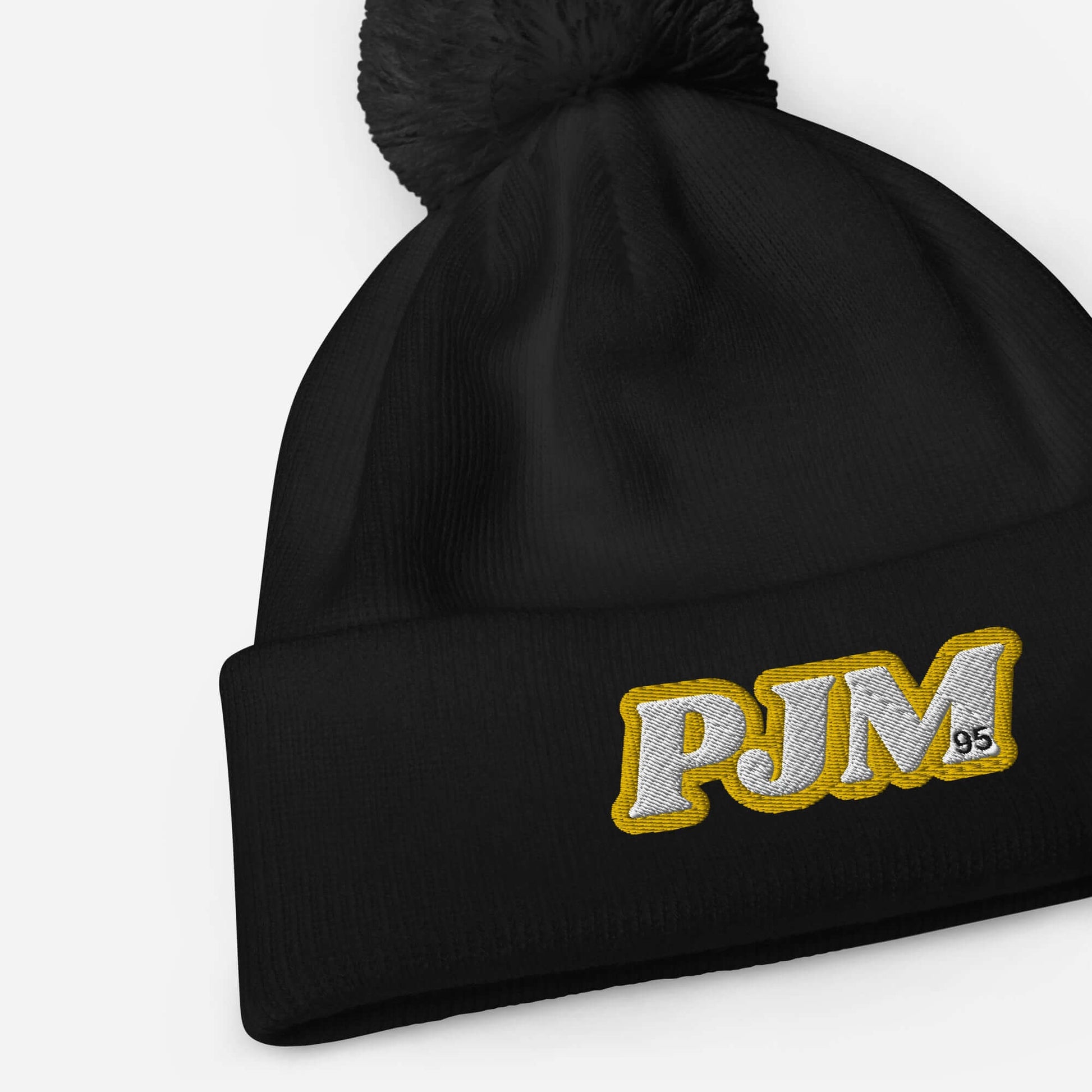 Black Jimin Pom Pom Beanie with PJM logo, cozy winter charm for ARMY fans.