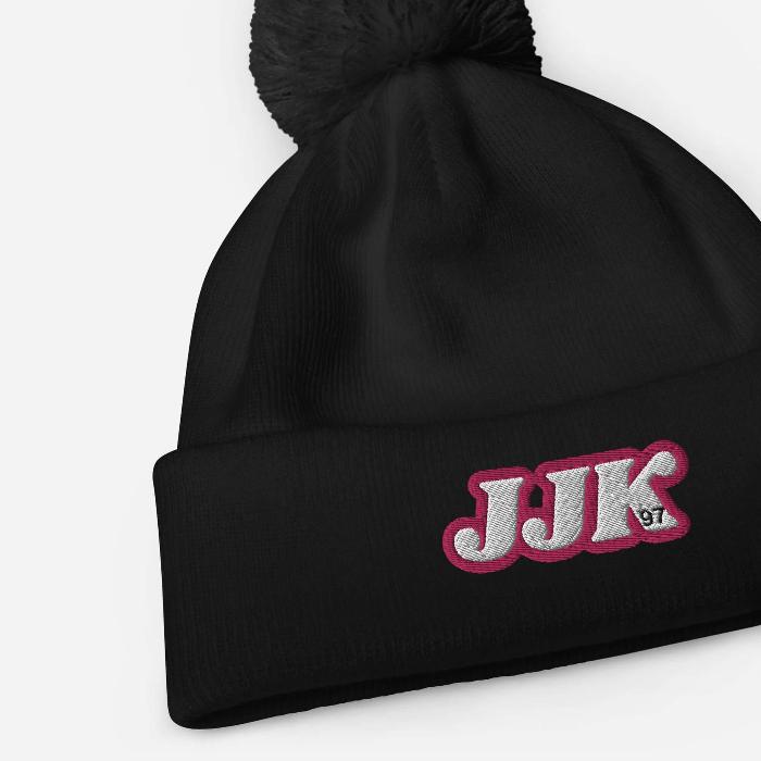 Bold black pom pom beanie with JJK 97 embroidery, inspired by Jung Kook. Soft-touch acrylic, perfect for winter adventures.