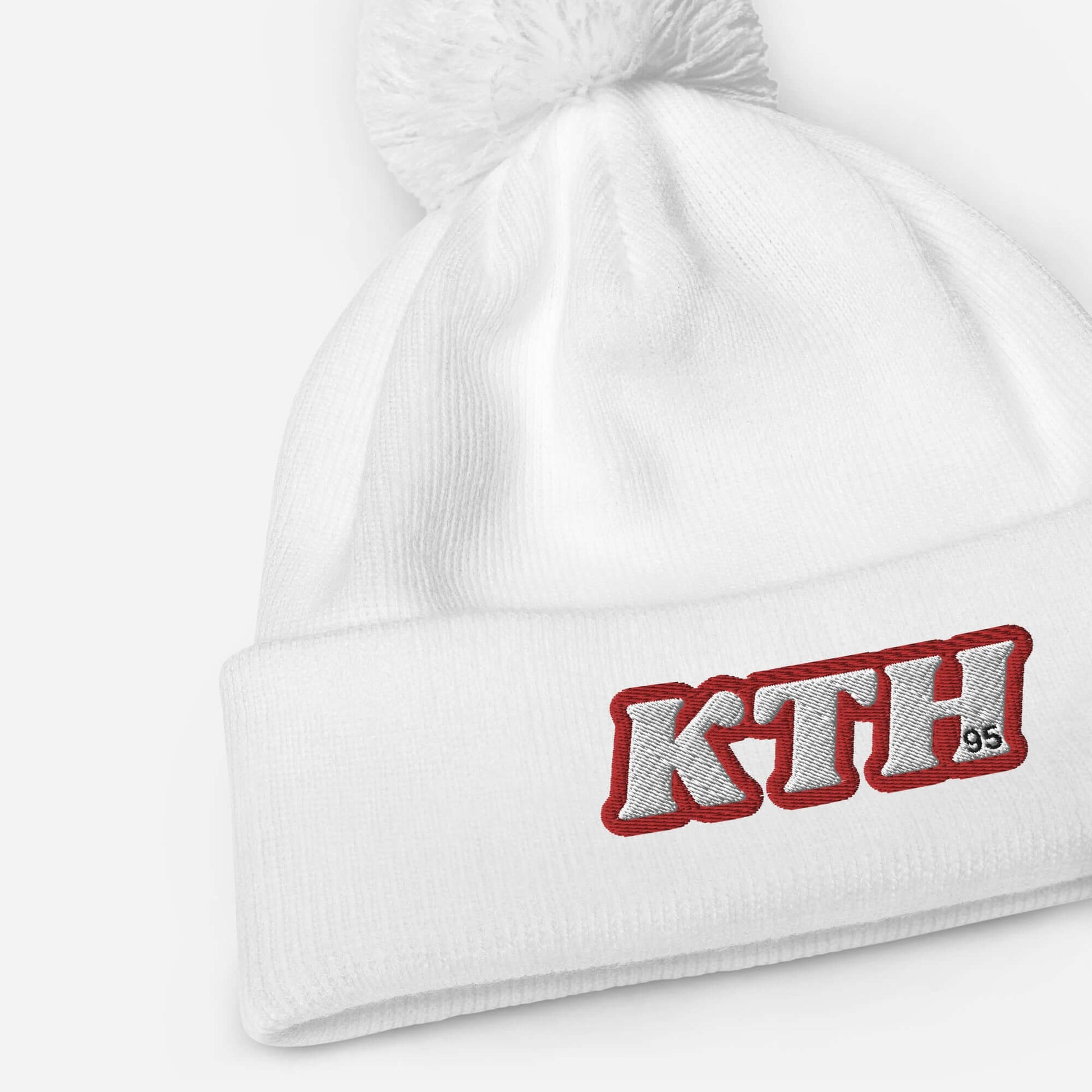 White beanie with red "KTH" embroidery and pom pom, inspired by Taehyung V of BTS, perfect for adding charisma and warmth.