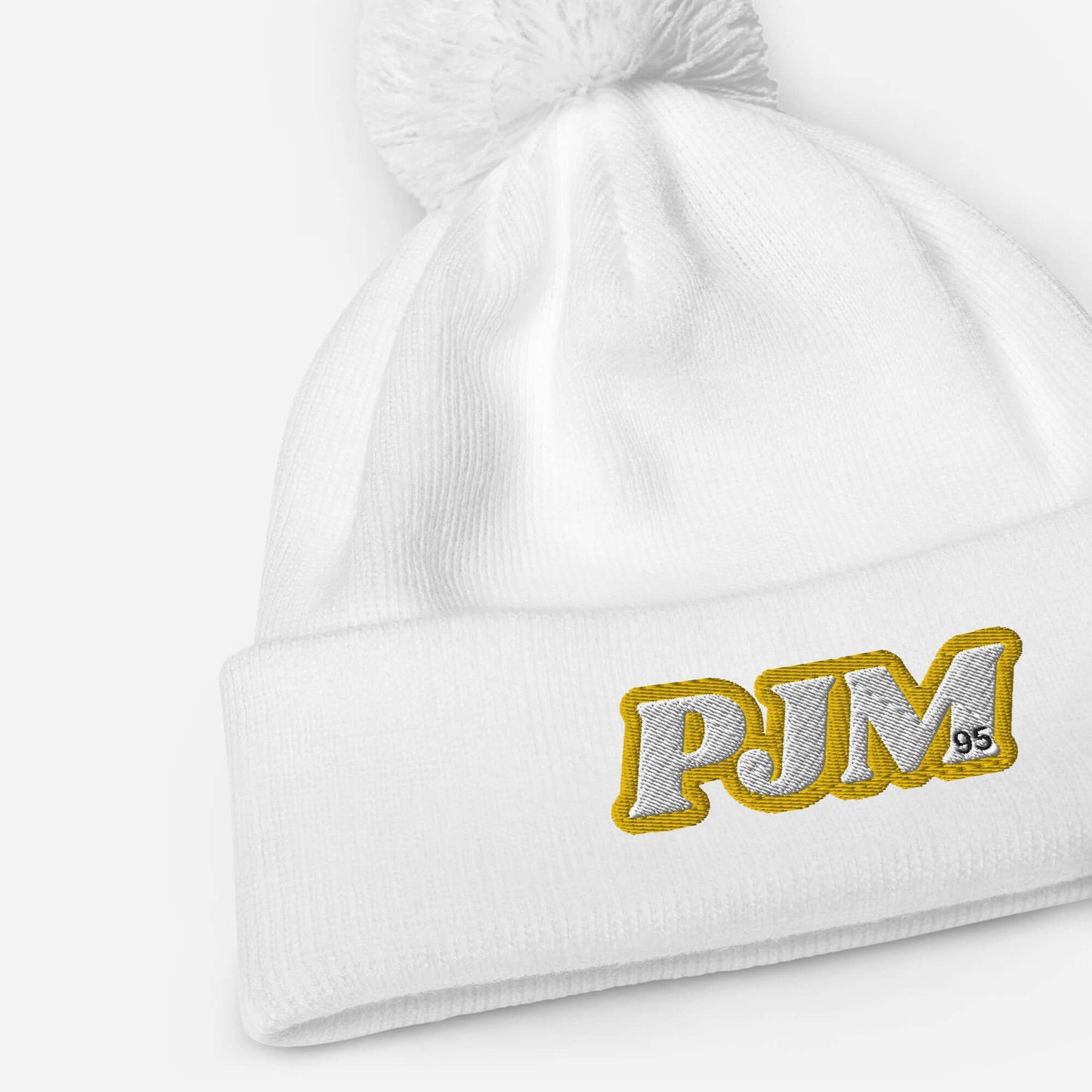 Jimin Pom Pom Beanie in white with PJM initials, cozy charm for winter warmth and style, perfect for ARMY fans.